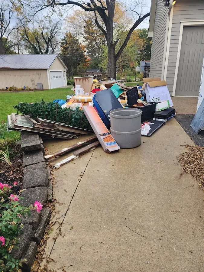 Dumpster being loaded with debris for Estate Cleanout Dumpster Rental in Surprise